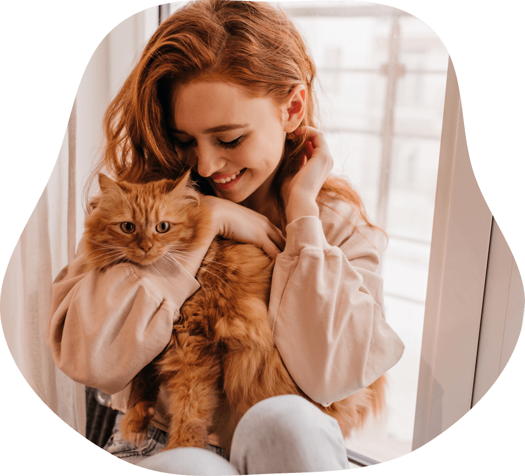Woman holding orange cat